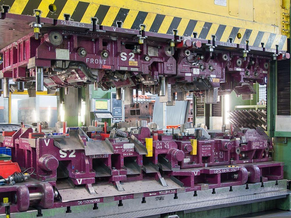 Large transfer tool inside a manufacturing line used for forming metal components